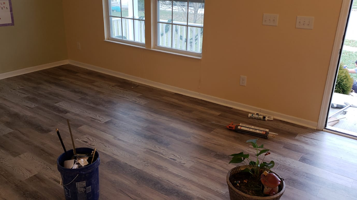 Freshly installed light gray wood-look plank flooring in a living room